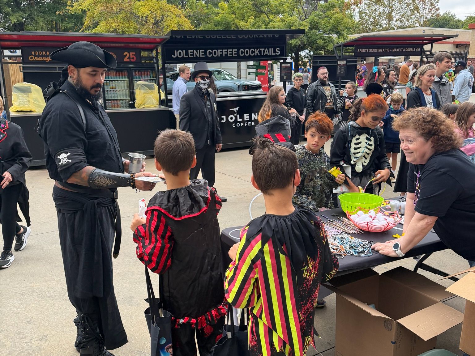Lux Dentistry handing out treats to kids in costume at a local Halloween event