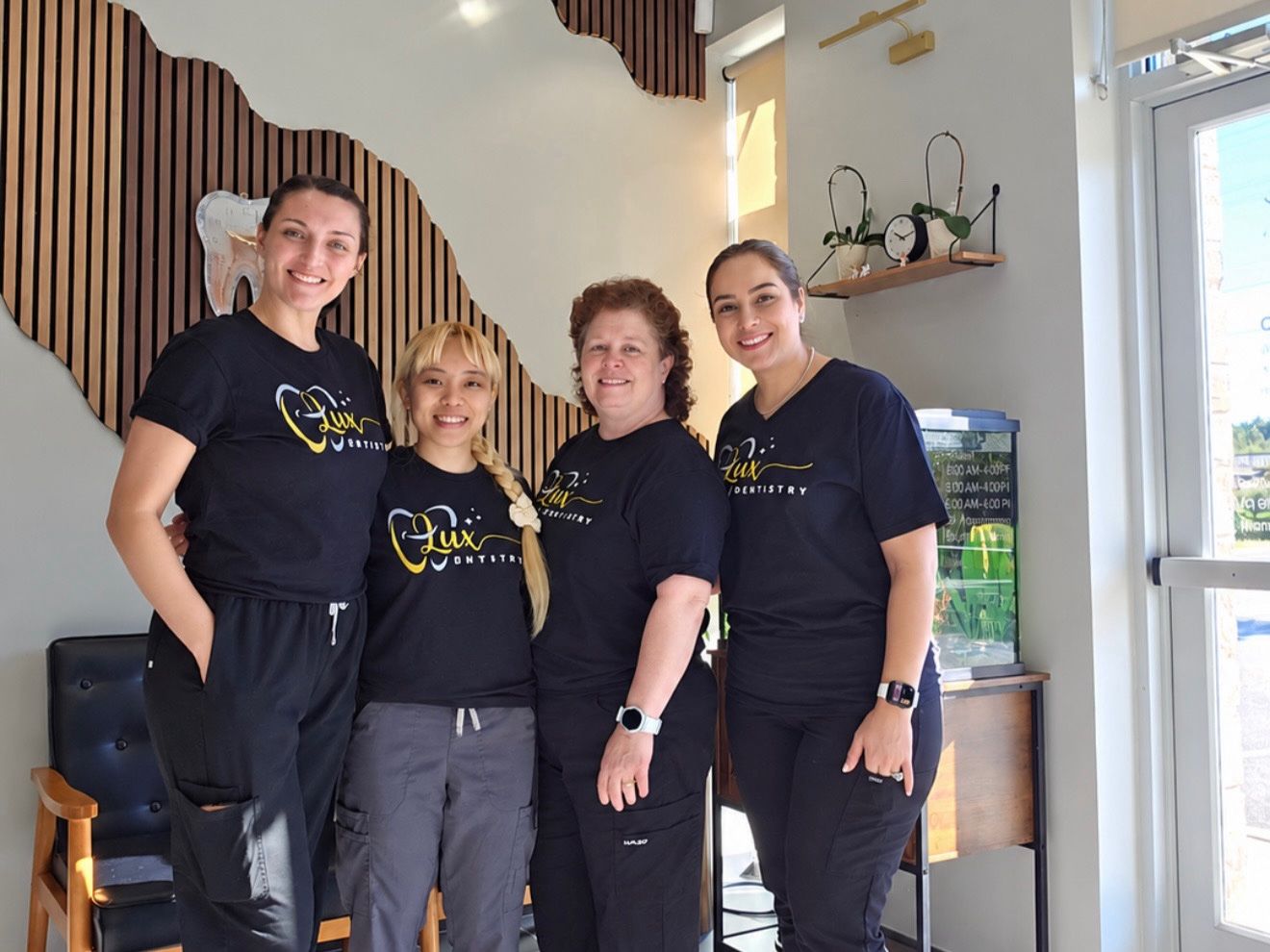 The Lux Dentistry team in matching Lux Dentistry shirts at the office