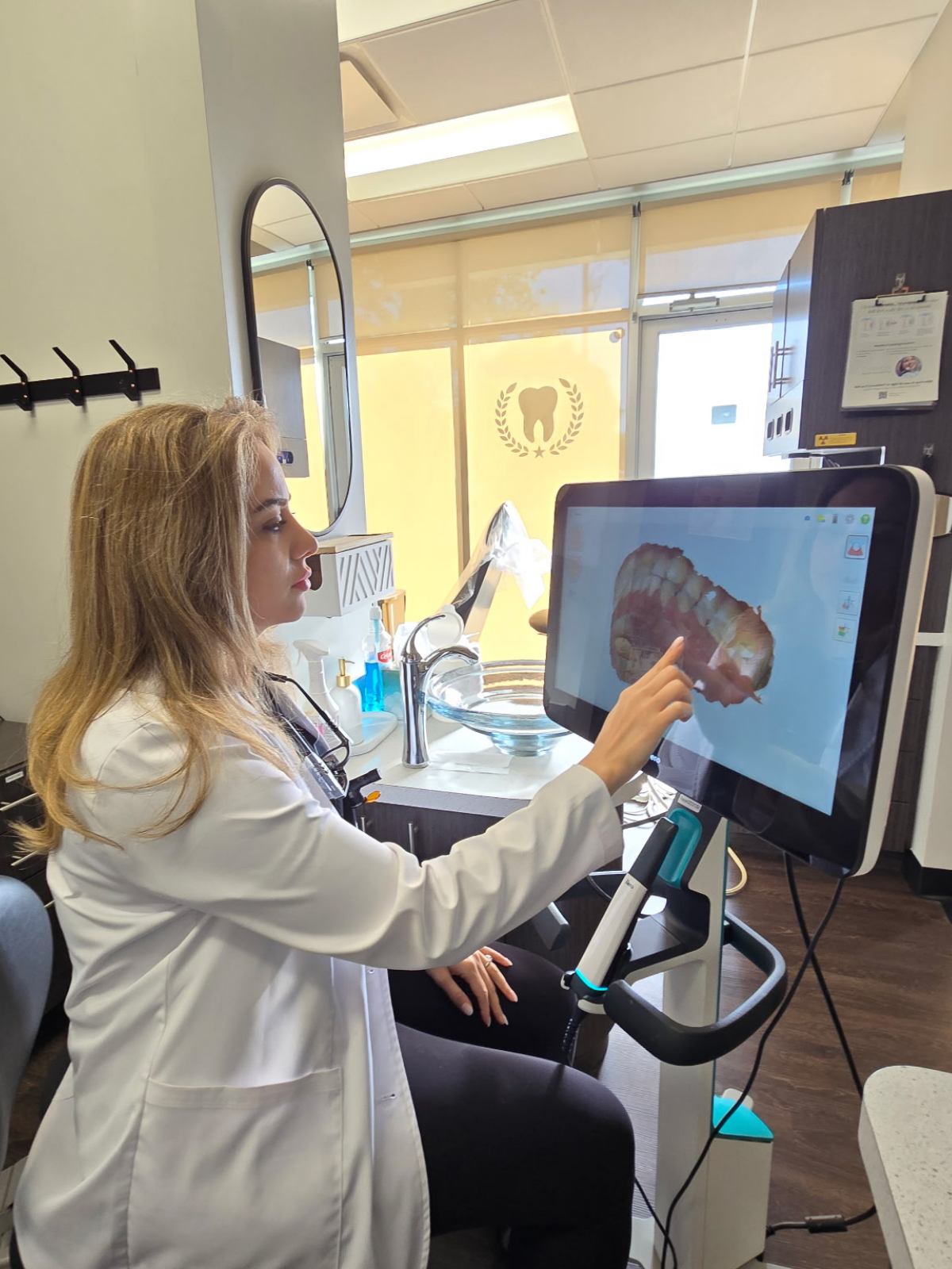 Dr. Doroudgar reviewing a 3D digital scan of a patient’s teeth on a chairside screen