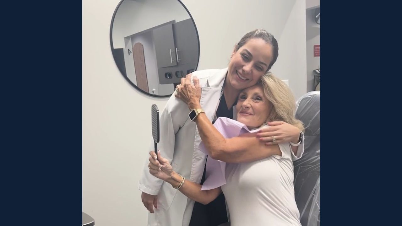 Dr. Doroudgar hugging a smiling patient after treatment