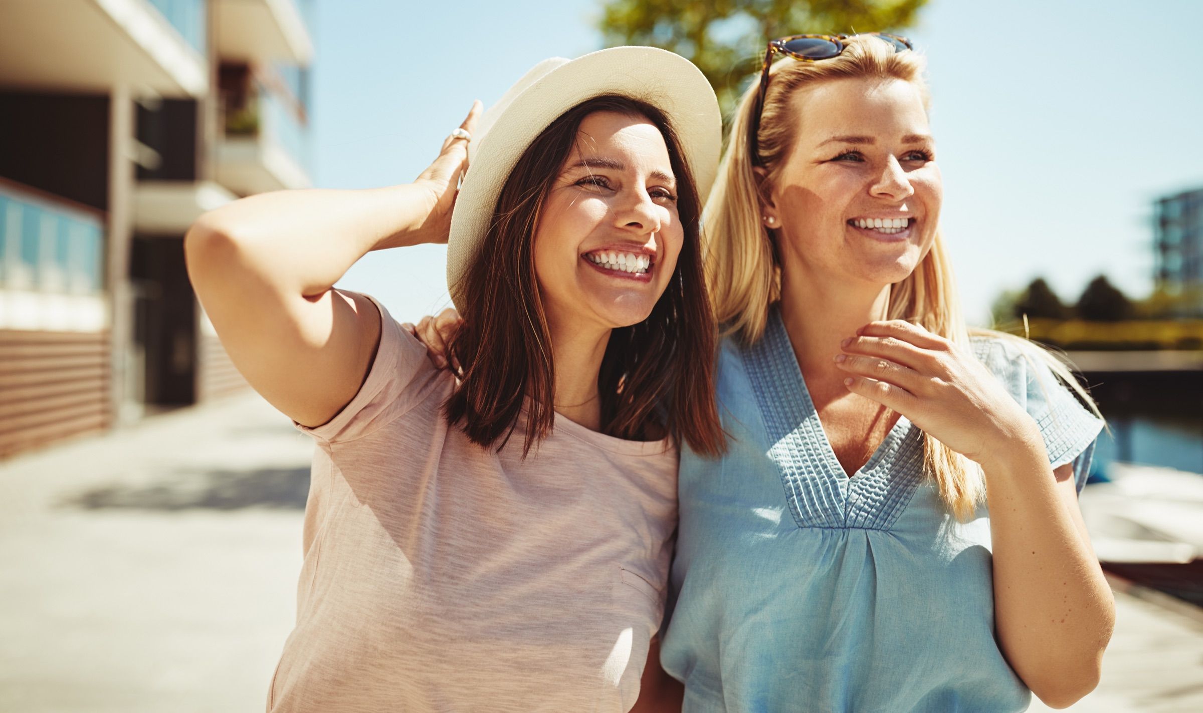 Two smiling women enjoying a sunny day outdoors