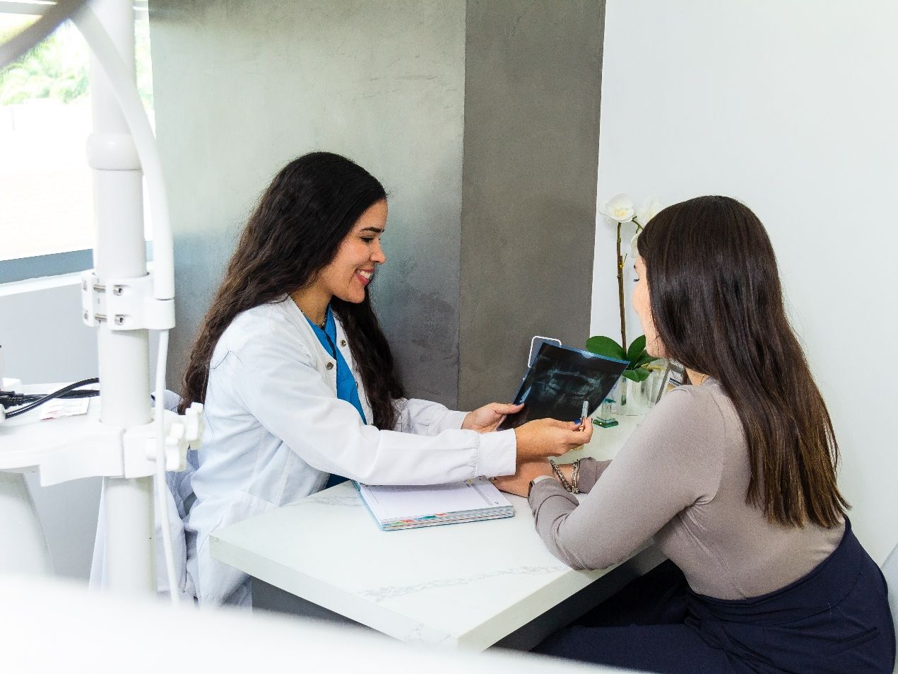 Dentist discussing how a smile makeover works with patient