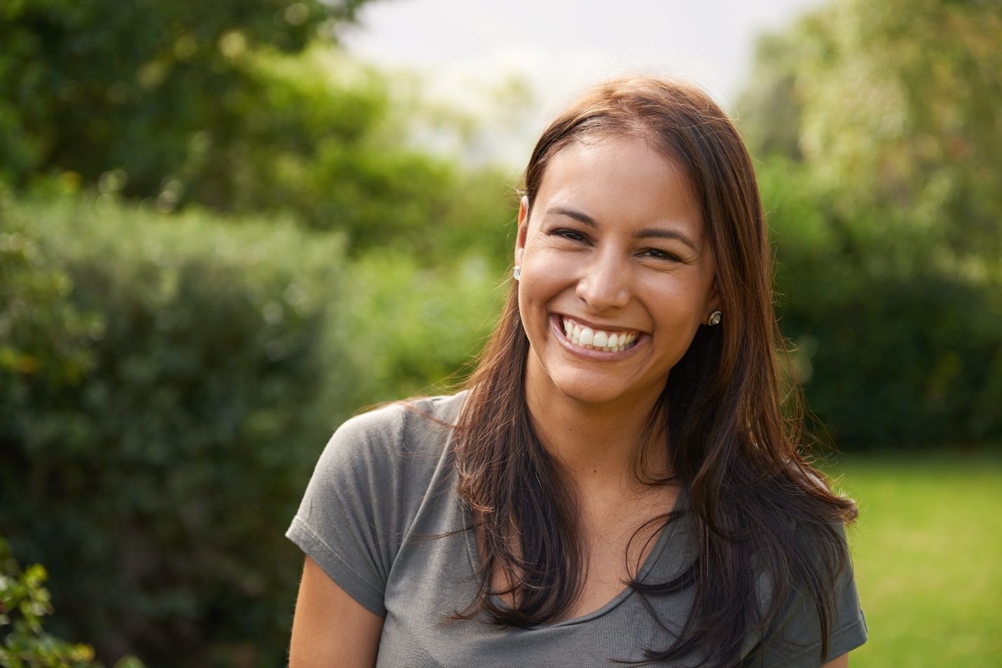 Woman standing in middle of field and smiling