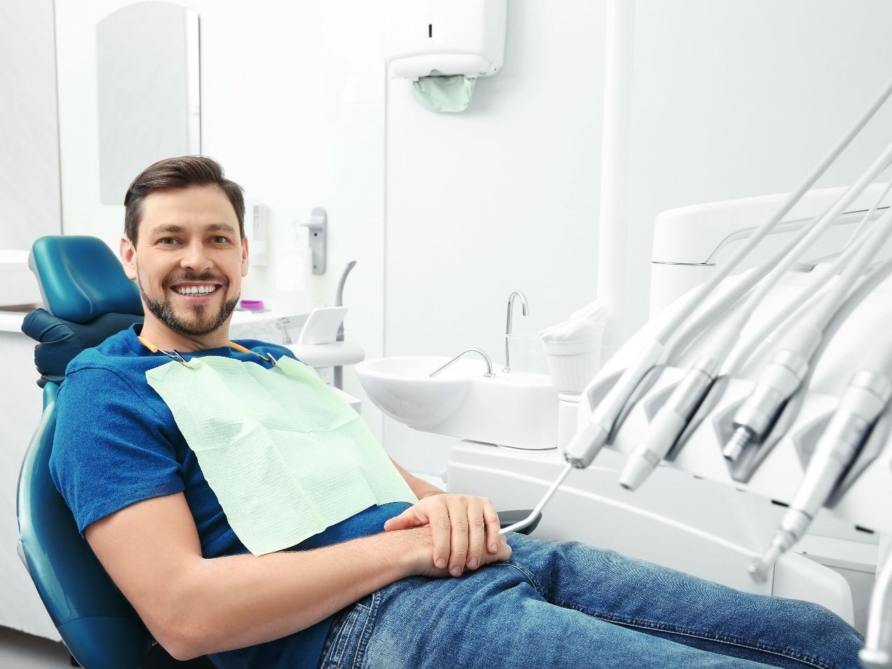Man sitting back in dental chair and smiling