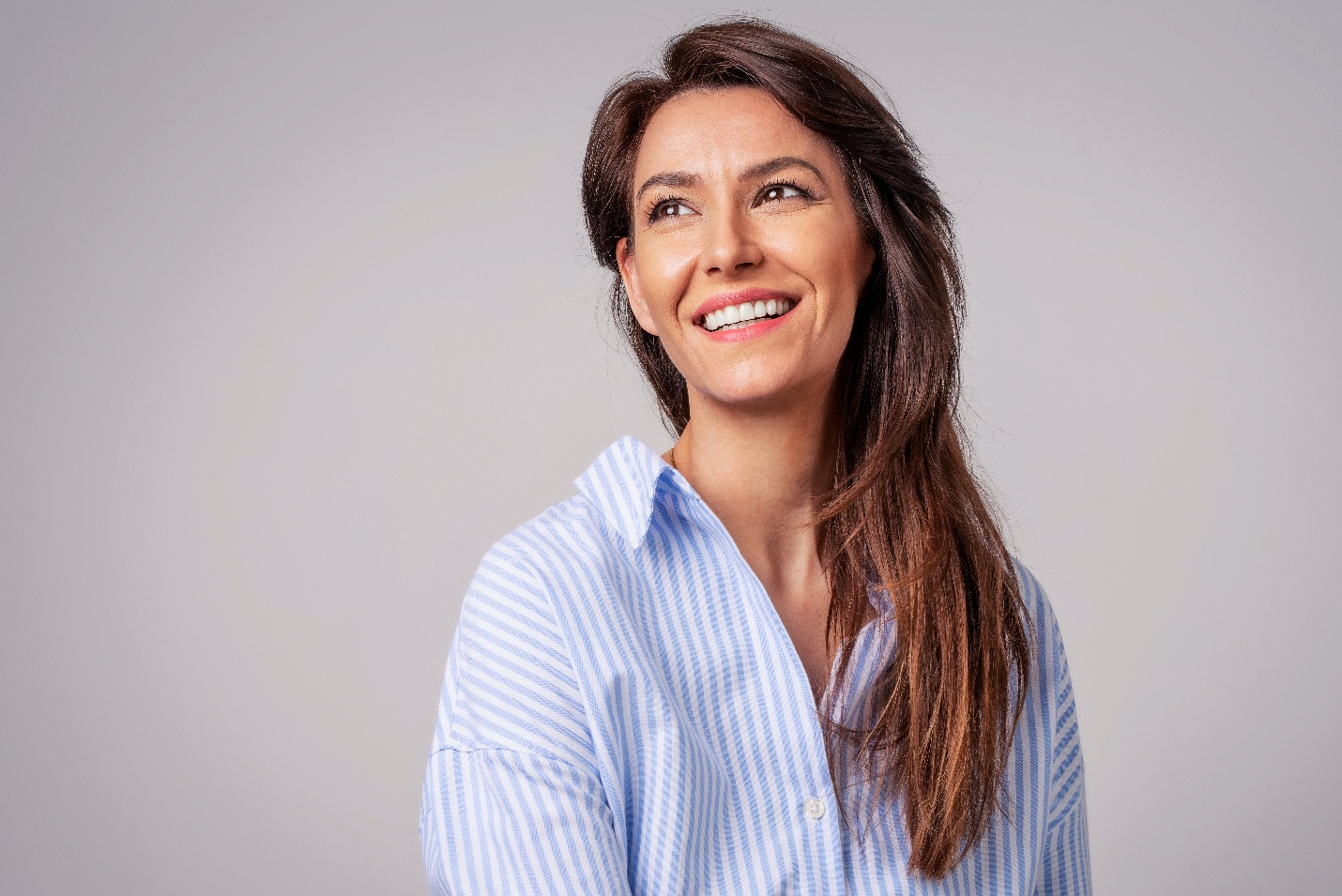 Closeup of woman in button-up shirt smiling